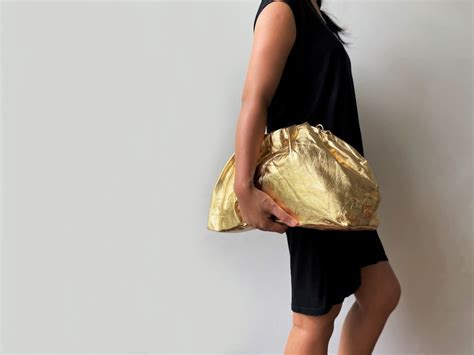 oversized gold clutch bag